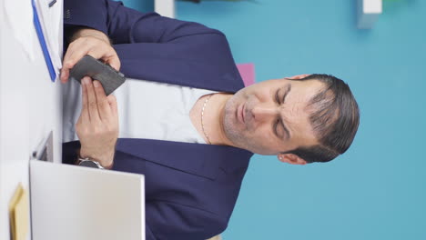 Vertical-video-of-Businessman-showing-his-empty-wallet-to-the-camera.